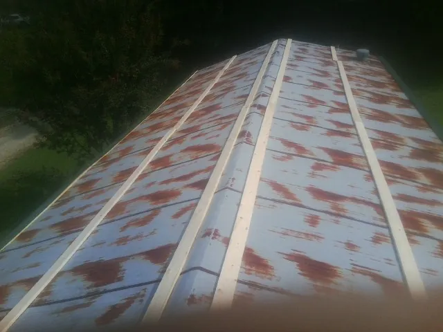 Rusted metal roof panels with new wood purlins before replacement — Storm Damage Roof Repair in Moxahala by Roofing Brothers